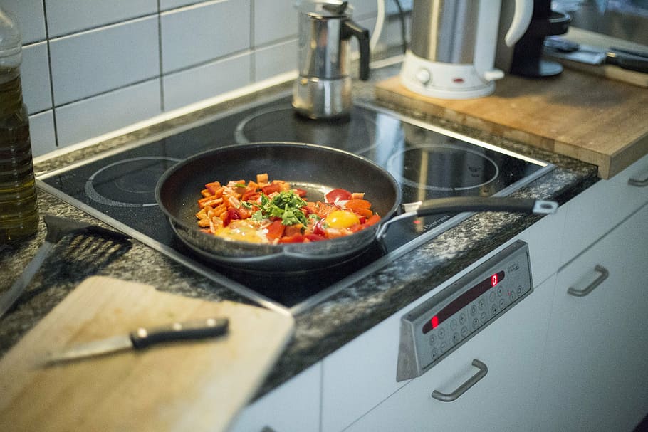 cooking pan on induction with sliced vegetables, food, kitchen