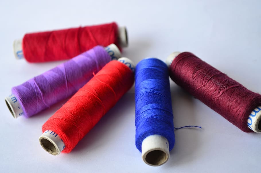 sewing thread rolls in white surface, threads, blue, brown HD wallpaper