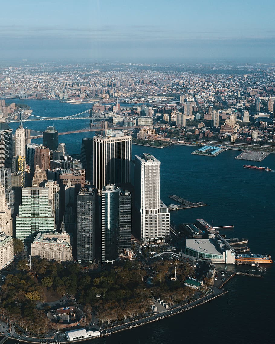 bird's-eye view photography of city buildings near body of water HD wallpaper