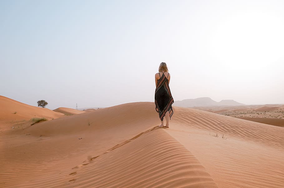 woman walking on desert during daytime, woman stands on brown sand, HD wallpaper