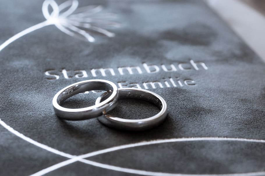 two silver-colored rings on gray textile, wedding rings, stud book HD wallpaper