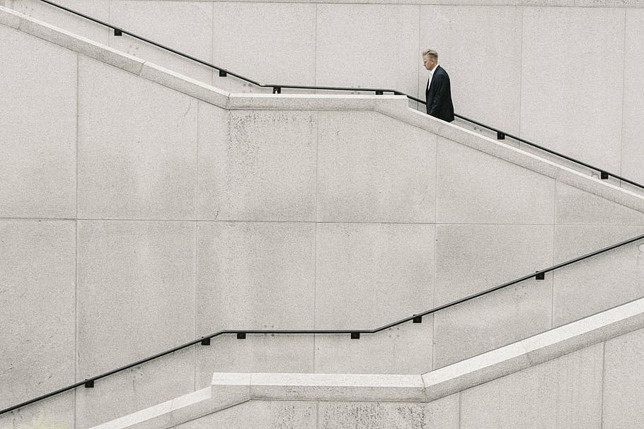 man walking on the stairs beside the wall, people, formal, alone, HD wallpaper