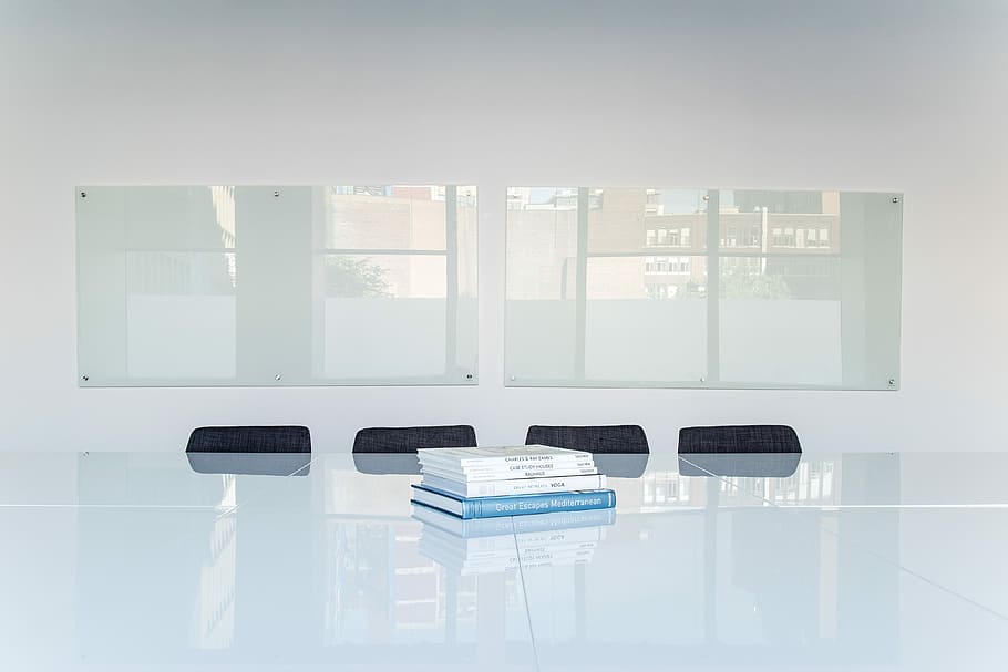 Books in a meeting space, pile of books on top of glass table HD wallpaper