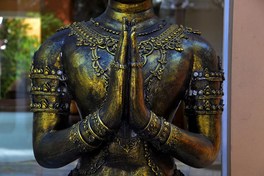 closeup photo of gold-colored statue, hands, praying, brass, religion