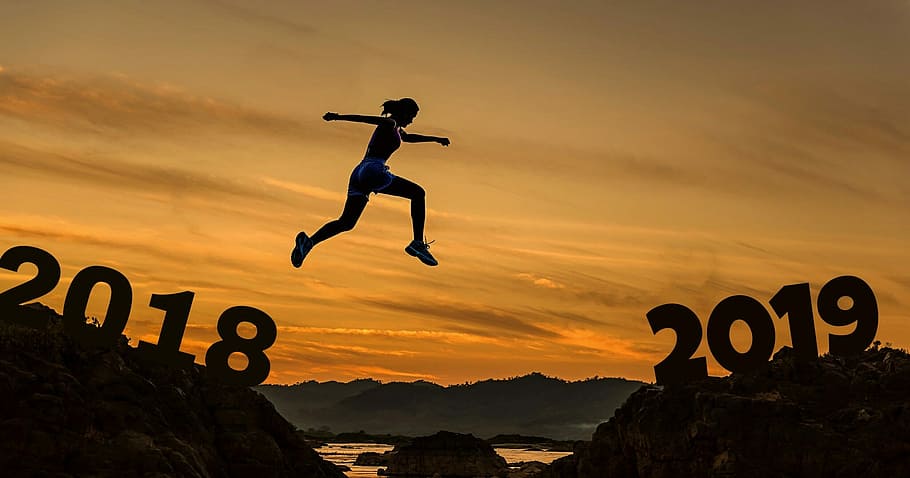 silhouette of woman jumping between rock formation during golden hour, HD wallpaper