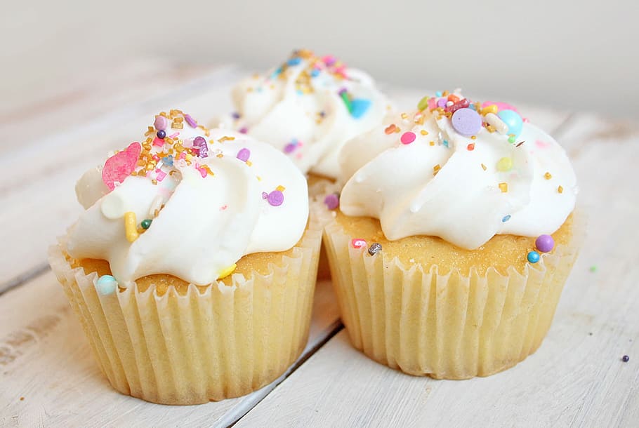 Cupcakes with pastel sprinkles, three cupcakes with toppings
