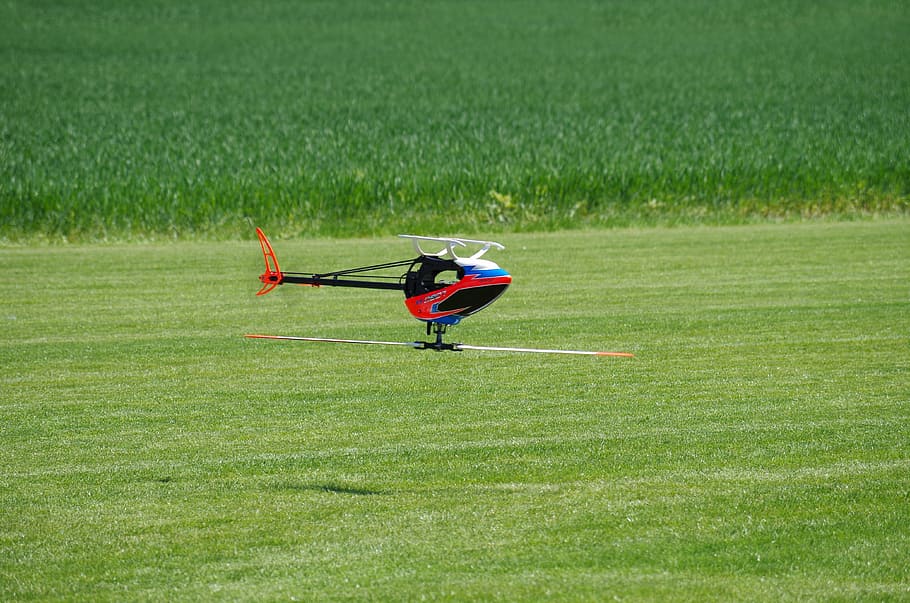 helicopter, model, flying, upside down, grass, plant, field HD wallpaper
