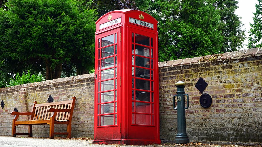red payphone near brown wooden bench, british, telephone, box