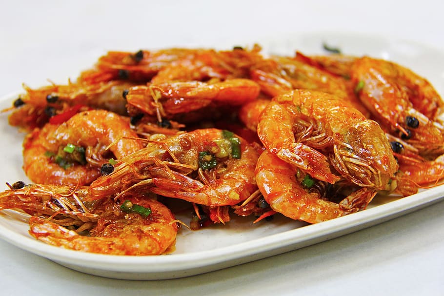 cooked shrimps on white plate, fried prawn, seafood, lunch, dinner