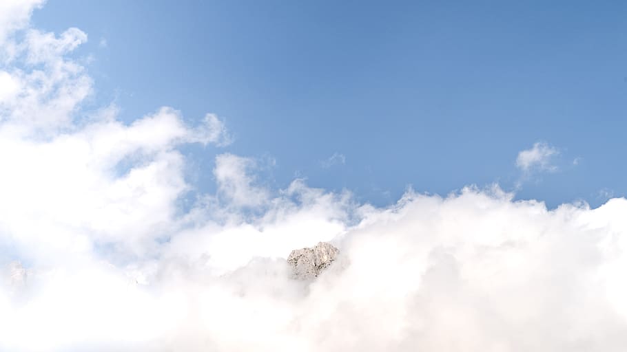 mountain between clouds, aerial photography of clouds and sky HD wallpaper