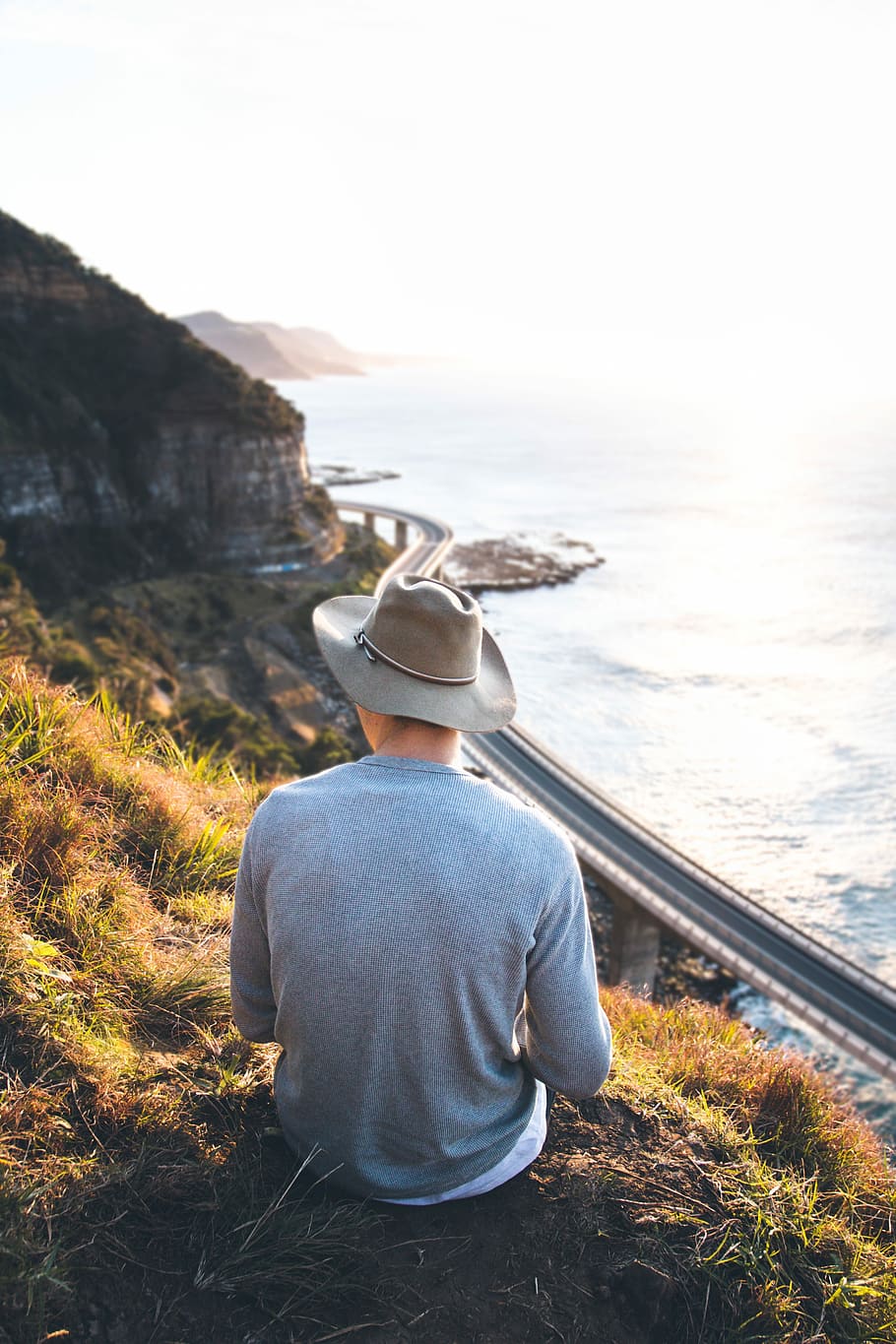 man sitting on the grass wearing hat and long sleeves shirt, one Person HD wallpaper