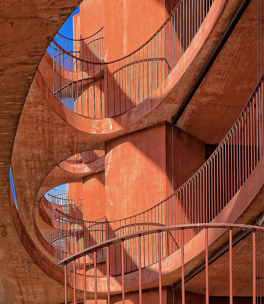 low angle photography of orange concrete building, portrait photography of orange staircase