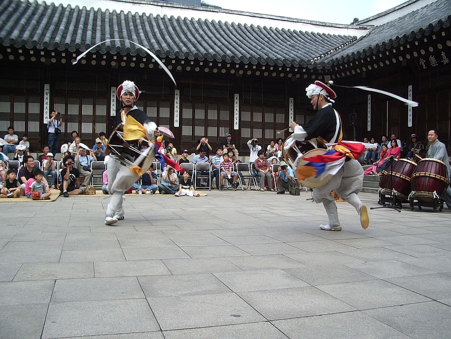 two person dancing traditional dance surrounded by people during daytime HD wallpaper