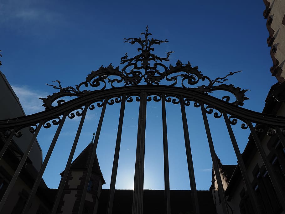 low angle photography of black gate under blue sky during daytime HD wallpaper