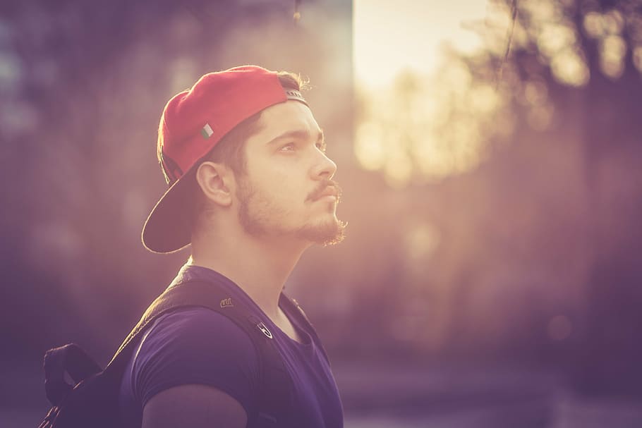 man wearing red flat-brim cap in tilt shift lens shot, boy HD wallpaper