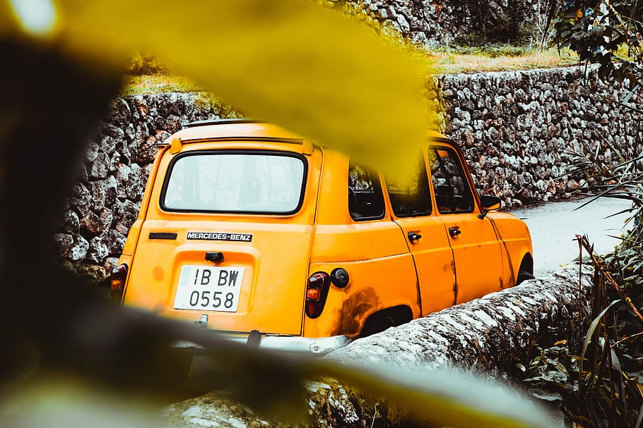 yellow car near stone wall at daytime, vintage yellow car, vehicle HD wallpaper