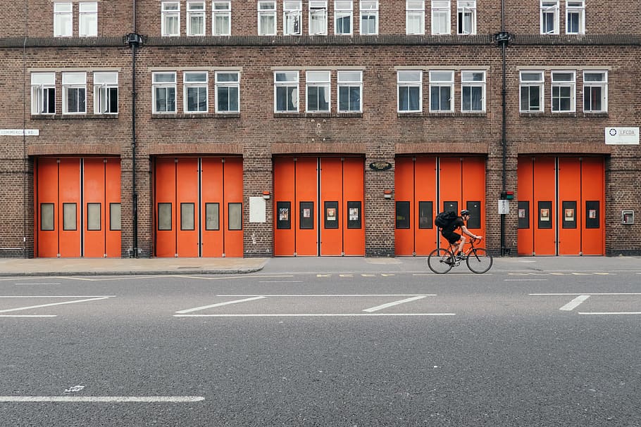 human riding bicycle on the road during day time, man cycling in the middle of street HD wallpaper
