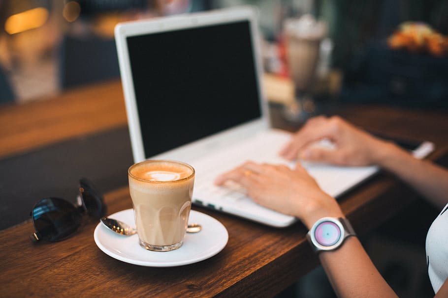 person using white laptop beside coffee latte, keyboard, technology HD wallpaper