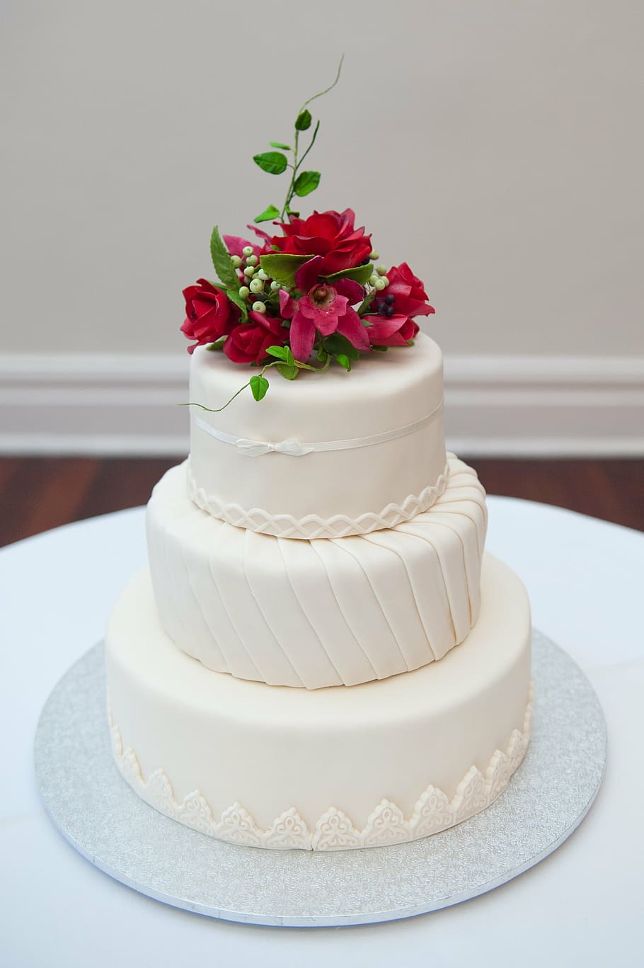 3-tier cake with pink petaled flowers on top, wedding cake, sweet