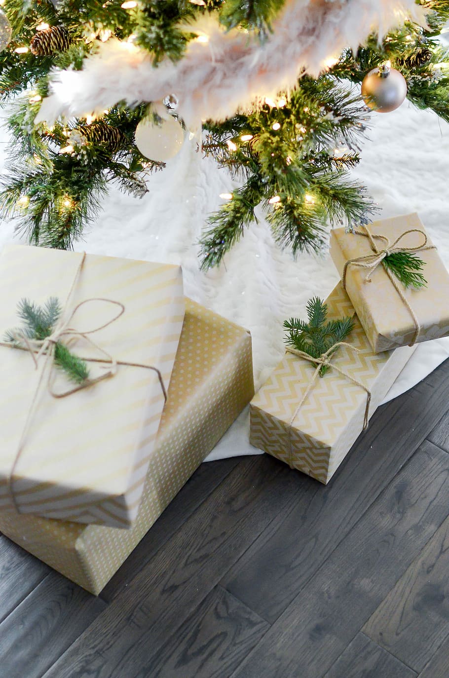 four gift boxes under Christmas tree, four white gift boxes on Christmas tree skirt HD wallpaper