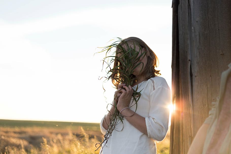 woman covering her face using plant, white, shirt, holding HD wallpaper