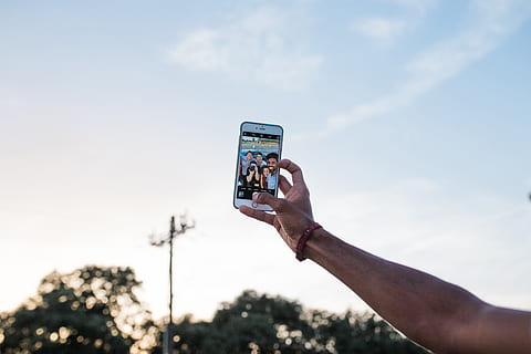 A man taking a selfie with his iPhone mobile smartphone, technology HD wallpaper