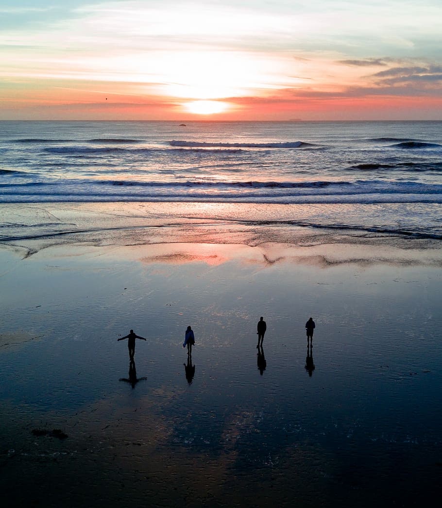 silhouette of four people on body of water under gray clouds during golden hour, four person standing on shoreline during golden hour HD wallpaper