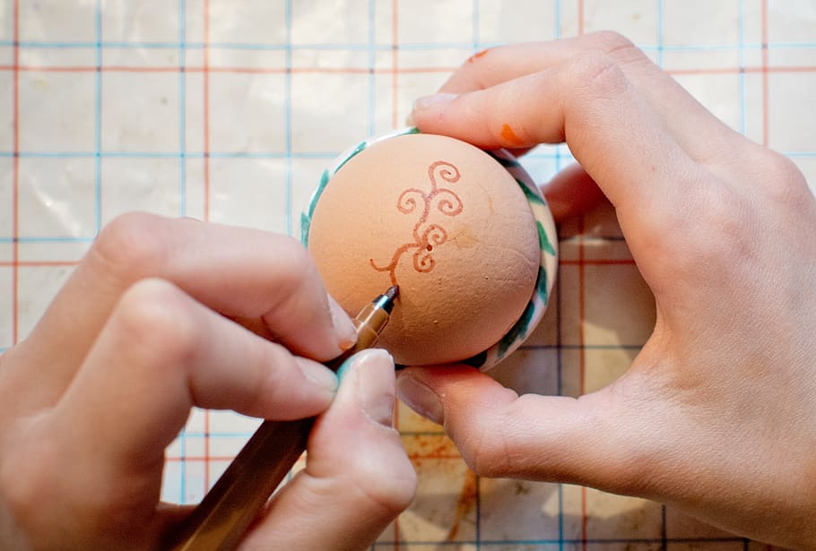 person drawing art on organic egg, easter egg, paint, pen, finger HD wallpaper