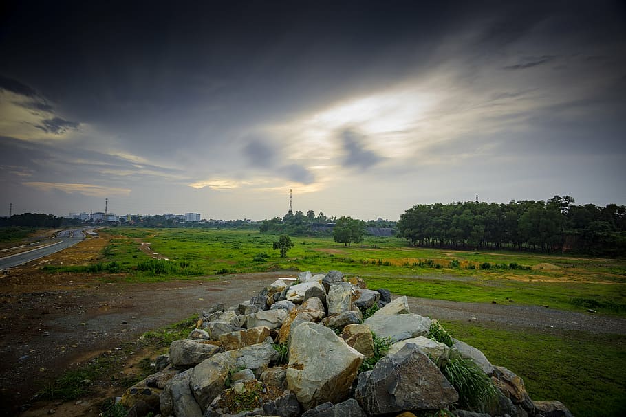 dark clouds, grass, landscape, road, rocks, trees, nature, sunset HD wallpaper