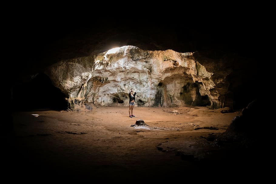 person standing at center of cave, people, woman, alone, light, HD wallpaper