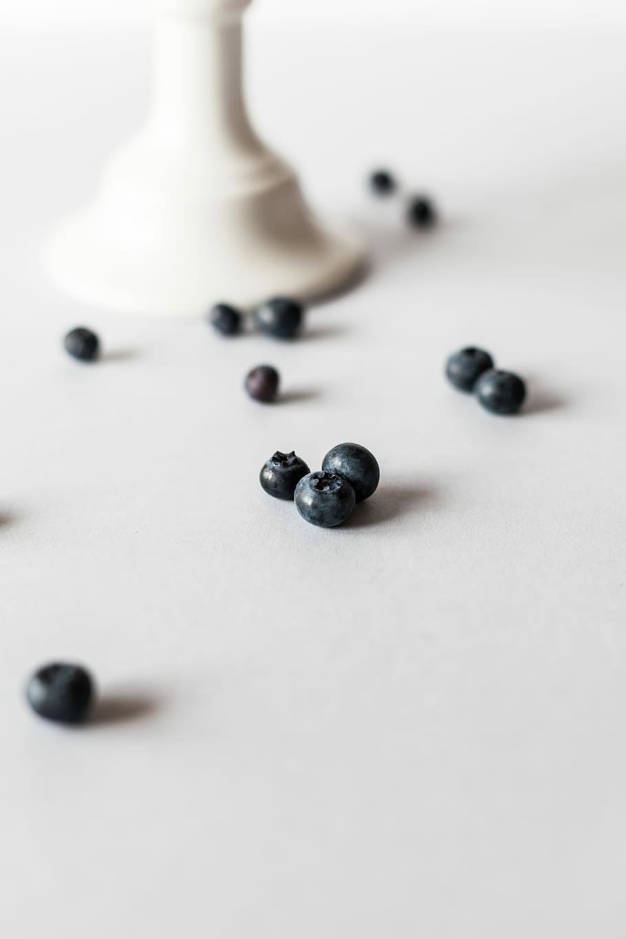 closeup photo of seed on white surface, selective focus photography of beads HD wallpaper