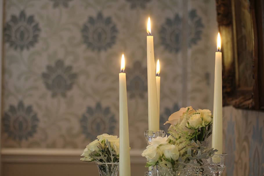 lighted white taper candles beside white rose flowers bouquets HD wallpaper