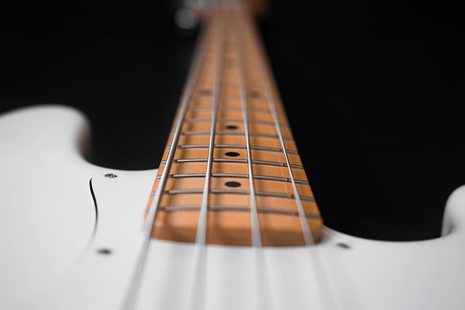 close-up photography of white 4-string bass guitar, close up