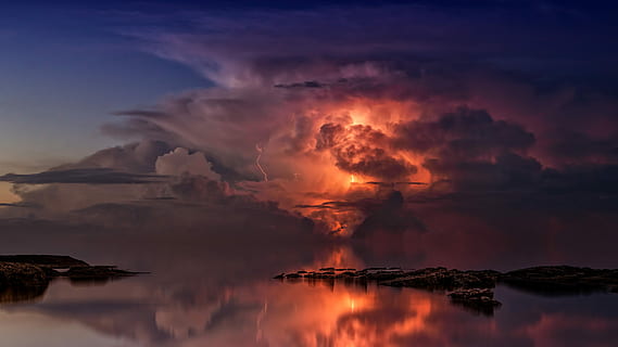 reflection of lightning on body of water during golden hour HD wallpaper