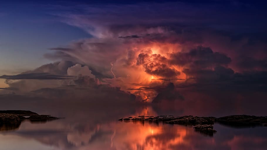 reflection of lightning on body of water during golden hour HD wallpaper