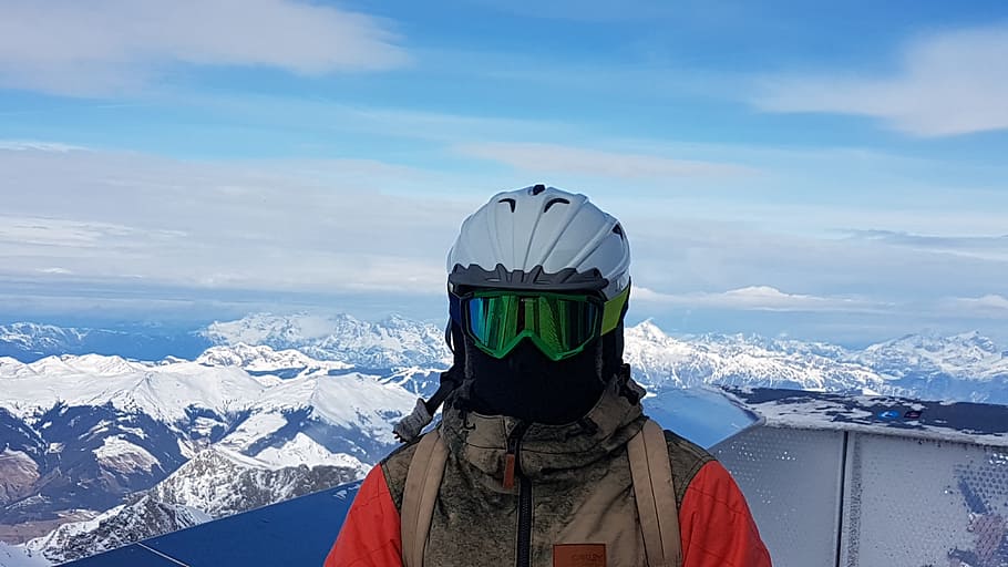 man wearing white helmet standing, ski glasses, ski helmet, ski mask