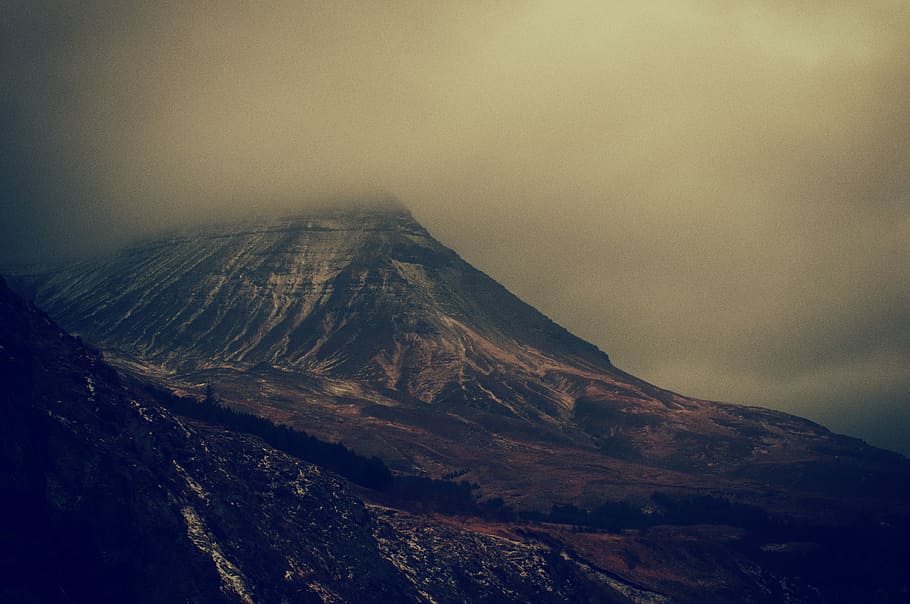 aerial photo of mountain, mountain surrounded with fogs under gray cloudy sky HD wallpaper