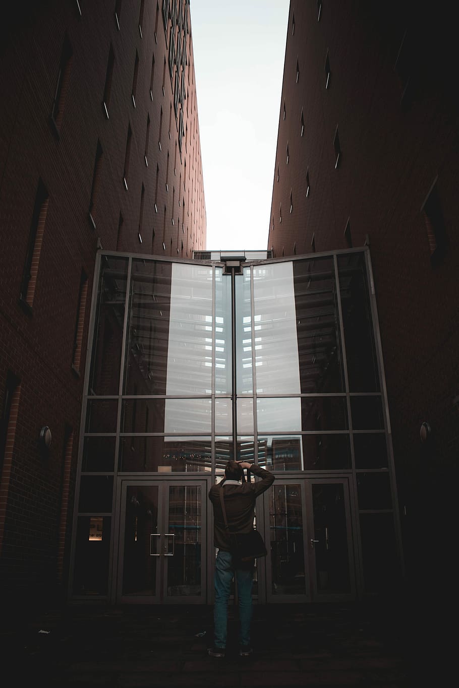 Big giant, man standing on grass door between buildings during daytime HD wallpaper