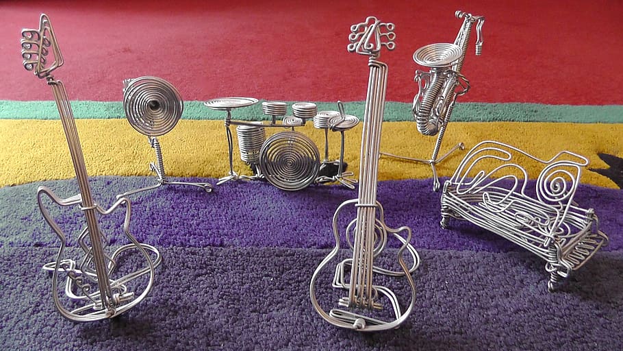 gray steel musical instrument mini figure on purple rug, intruments