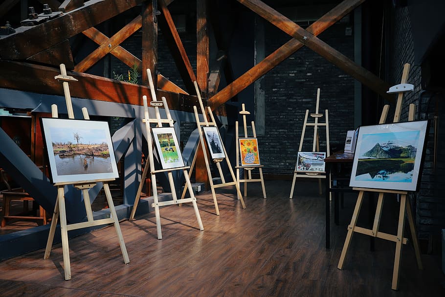 five assorted paintings on easels, assorted painting on wooden easel HD wallpaper