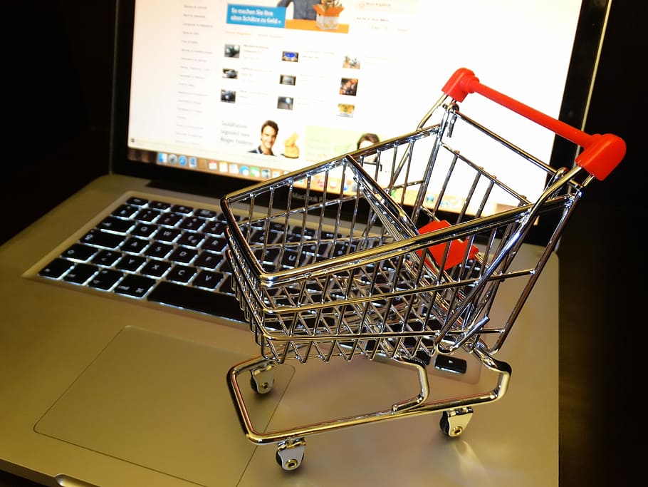 stainless steel push cart toy on top of MacBook, purchasing, shopping cart