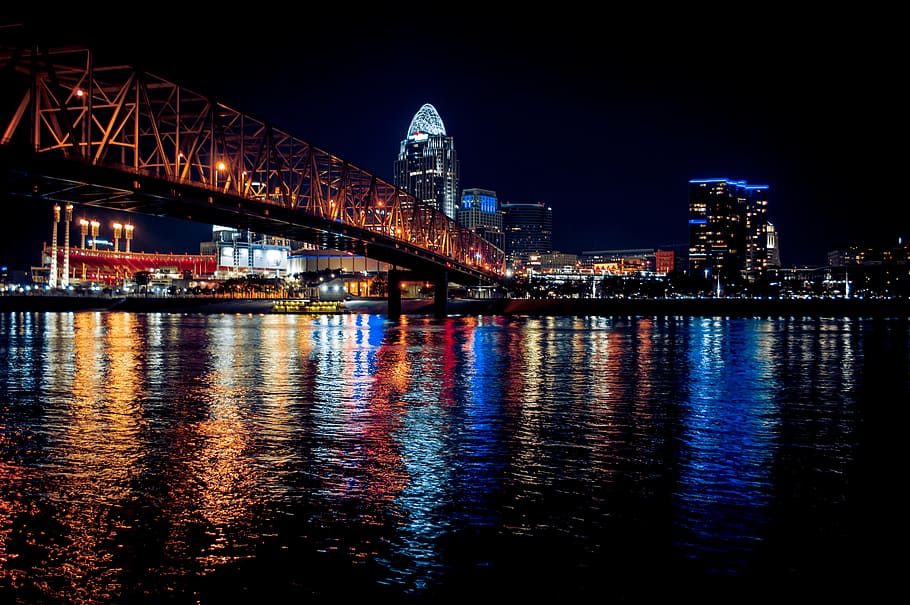 body of water under bride during night, low light photography of high-rise buildings HD wallpaper