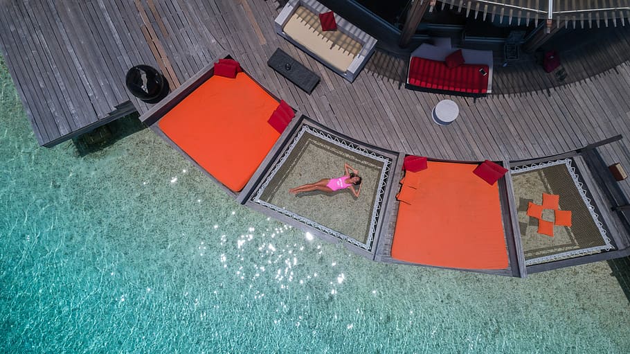 aerial view photography of woman floating on body of water, aerial photograph of woman floating in body of water during daytime HD wallpaper