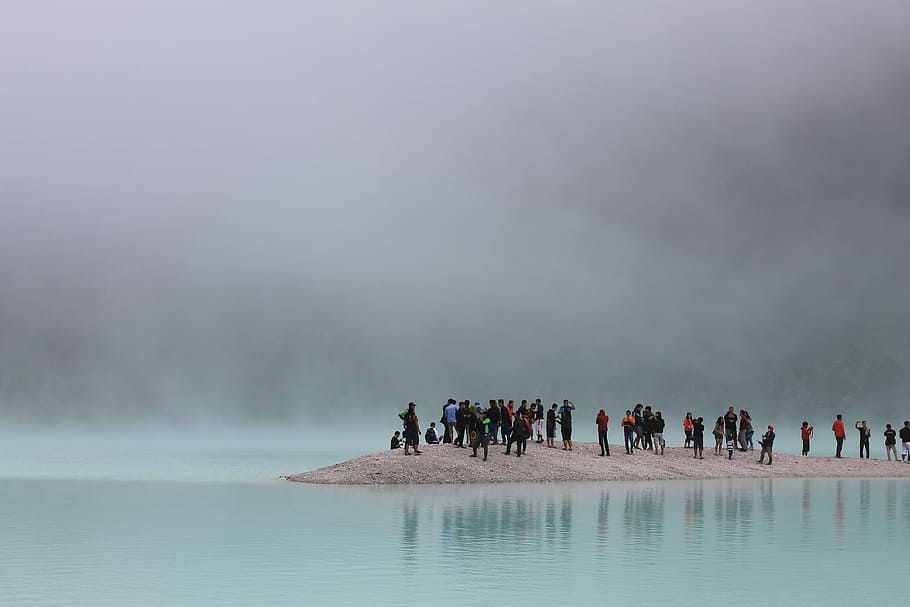 group of people standing on brown stand surrounded by body of water, people standing on soil near water with steam, HD wallpaper