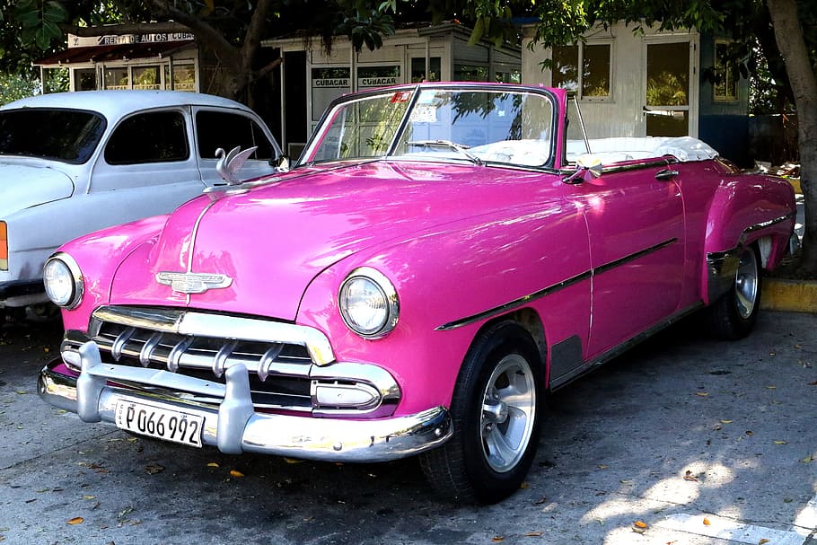 classic pink convertible coupe parked near white vehicle, Car