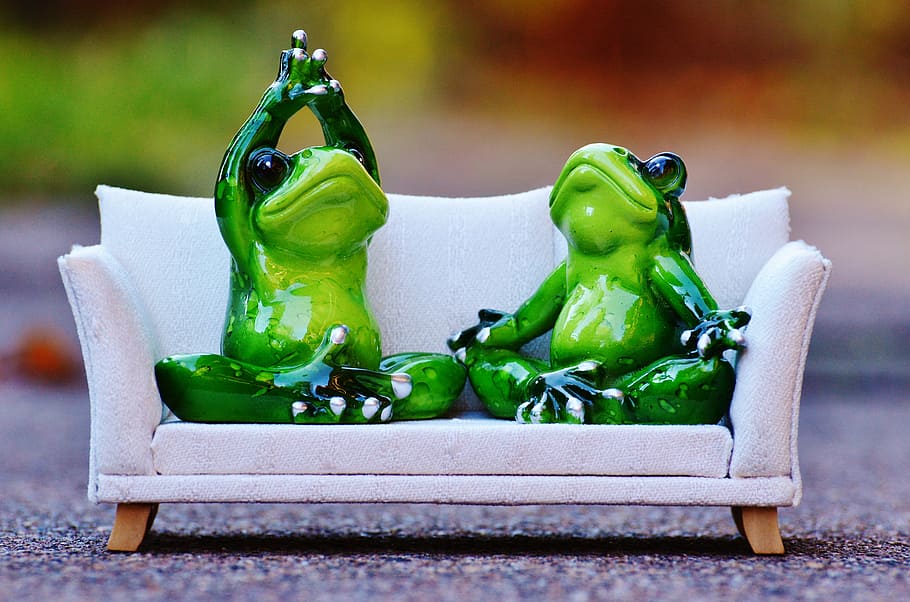 two ceramic frog figurines on white couch model scale, sofa HD wallpaper
