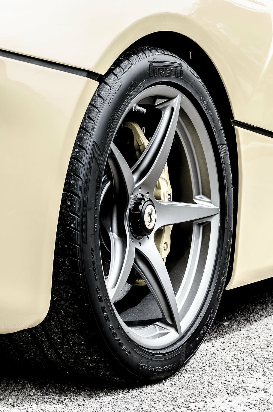 close-up photo of gray Ferrari 5-spoke vehicle wheel with tire