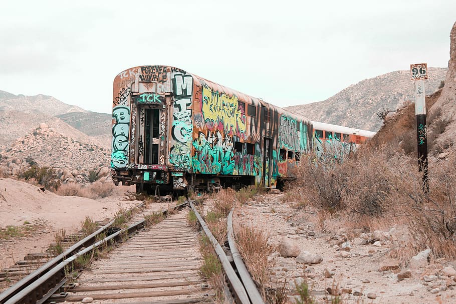 lost in the wilderness, photo of multicolored train on train tracks during daytime HD wallpaper
