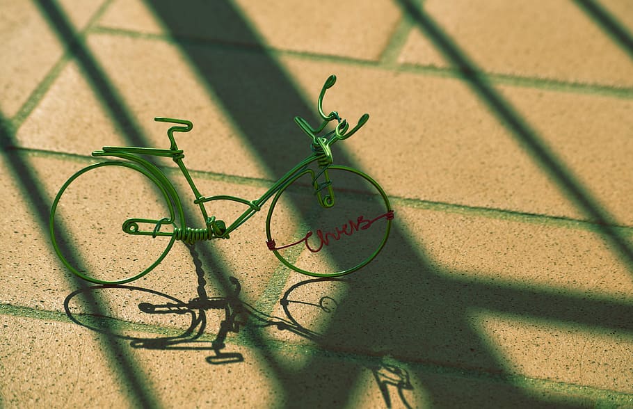 gray bicycle miniature on concrete pavement, green wire bicycle HD wallpaper