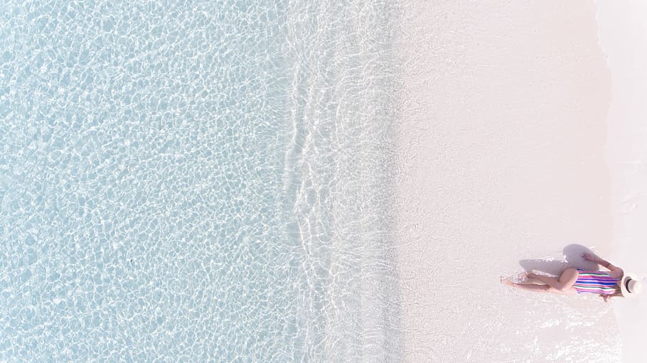 aerial view photography of woman sunbathing on seashore, aerial photography of woman lying on seashore HD wallpaper
